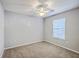 Bright, empty bedroom featuring neutral carpet, fan, and a bright window at 188 Midland Pkwy # 516, Summerville, SC 29485