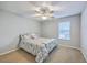 Well lit bedroom with a floral cover, featuring a ceiling fan and large window at 188 Midland Pkwy # 516, Summerville, SC 29485
