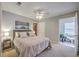 Comfortable bedroom features neutral carpet, fan, and an adjacent sunroom at 188 Midland Pkwy # 516, Summerville, SC 29485