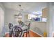 Charming dining area adjacent to kitchen, showcasing decorative lighting, and hardwood flooring at 188 Midland Pkwy # 516, Summerville, SC 29485