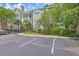 Exterior building view with mature landscaping, multiple trees, and ample parking on a partly cloudy day at 188 Midland Pkwy # 516, Summerville, SC 29485