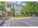 Exterior building view with mature landscaping, multiple trees, and ample parking on a partly cloudy day at 188 Midland Pkwy # 516, Summerville, SC 29485