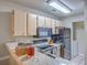 Bright kitchen featuring wood cabinets, a granite countertop, and appliances, washer and dryer area adjacent at 188 Midland Pkwy # 516, Summerville, SC 29485