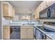 Well-equipped kitchen with stainless steel appliances and a double sink, open to the living area at 188 Midland Pkwy # 516, Summerville, SC 29485