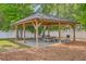 Open-air wooden pavilion with picnic tables and a barbecue grill for outdoor gatherings at 188 Midland Pkwy # 516, Summerville, SC 29485