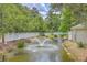 Scenic pond with a fountain surrounded by lush greenery and a white picket fence at 188 Midland Pkwy # 516, Summerville, SC 29485