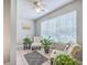 Cozy sunroom with neutral paint and tile floors, flooded with natural light from a large window at 188 Midland Pkwy # 516, Summerville, SC 29485