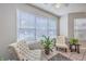 Bright sunroom with white chairs, filled with natural light from a large window at 188 Midland Pkwy # 516, Summerville, SC 29485