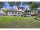 An exterior view of a home with a screened porch, lawn, and wooden playset at 1901 Bairds Cv, Charleston, SC 29414