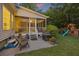 A screened porch leads to a backyard featuring a grill, playset, and lawn at 1901 Bairds Cv, Charleston, SC 29414