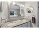 Bright bathroom with dual sinks, granite countertops, and two mirrors at 1901 Bairds Cv, Charleston, SC 29414