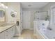Bright bathroom with tub, shower, and granite countertop sink at 1901 Bairds Cv, Charleston, SC 29414