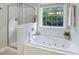 Bright bathroom with tub and separate shower at 1901 Bairds Cv, Charleston, SC 29414