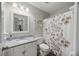 Bright bathroom with granite countertop sink and neutral shower curtain at 1901 Bairds Cv, Charleston, SC 29414