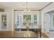 Bright dining area with a large window and elegant chandelier and access to the backyard at 1901 Bairds Cv, Charleston, SC 29414