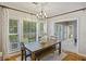 Bright dining area with large windows, a wooden table, and a view to the backyard at 1901 Bairds Cv, Charleston, SC 29414