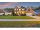 Charming two-story brick home with manicured lawn, landscape, and inviting front porch at 1901 Bairds Cv, Charleston, SC 29414