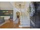 Spacious two-story foyer featuring hardwood floors, a staircase, and stylish decor at 1901 Bairds Cv, Charleston, SC 29414