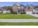 A charming brick home features a manicured lawn, front porch, and two car garage at 1901 Bairds Cv, Charleston, SC 29414