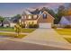 Beautifully landscaped brick home with a two-car garage, covered front porch, and inviting curb appeal at 1901 Bairds Cv, Charleston, SC 29414