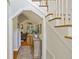 A hallway features hardwood floors, a neutral color scheme, and an arched entrance leading to the living room at 1901 Bairds Cv, Charleston, SC 29414