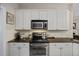 Modern kitchen features stainless steel appliances, granite countertops, and white cabinets at 1901 Bairds Cv, Charleston, SC 29414