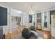 Bright living area with large windows, hardwood floors, and stairs to the second floor at 1901 Bairds Cv, Charleston, SC 29414