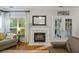 Cozy living room showcasing fireplace, hardwood floors, and natural light at 1901 Bairds Cv, Charleston, SC 29414