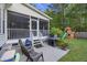 Outdoor patio with grill, seating, and stairs leading to a screened porch, with playset in yard at 1901 Bairds Cv, Charleston, SC 29414