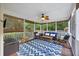 Comfortable screened porch furnished with stylish seating, ceiling fan, and outdoor views at 1901 Bairds Cv, Charleston, SC 29414