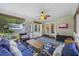Relaxing screened porch with comfortable seating, ceiling fan, and backyard view at 1901 Bairds Cv, Charleston, SC 29414