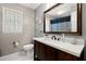 Charming bathroom with a modern vanity, decorative mirror, and marble tile flooring at 197 High Grove Rd, Summerville, SC 29485