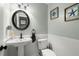 Charming powder room featuring a pedestal sink, stylish mirror, and coastal decor at 197 High Grove Rd, Summerville, SC 29485