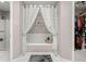 Inviting bathtub with white subway tile surround, decorative curtains, and coordinated accents at 197 High Grove Rd, Summerville, SC 29485