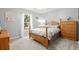 Serene bedroom with light gray walls, a wooden bed frame, and a sunny window view at 197 High Grove Rd, Summerville, SC 29485