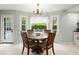 Charming dining room with a round table, wood chairs, chandelier, and a bright window at 197 High Grove Rd, Summerville, SC 29485