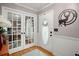 Welcoming entryway with hardwood floors, a decorative rug, and stylish French doors leading to a living area at 197 High Grove Rd, Summerville, SC 29485