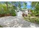 A two-story house featuring a spacious driveway and well-maintained lawn, surrounded by trees at 197 High Grove Rd, Summerville, SC 29485