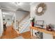Elegant foyer with hardwood floors, white staircase, stylish mirror, and decorative accents at 197 High Grove Rd, Summerville, SC 29485