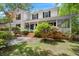 Charming two-story home featuring a welcoming front porch with brick steps and landscaped yard at 197 High Grove Rd, Summerville, SC 29485