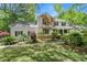 Beautiful two-story home with a inviting front porch and a beautifully landscaped yard with mature trees at 197 High Grove Rd, Summerville, SC 29485