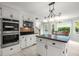 Bright kitchen with white cabinets, granite countertops, and stainless steel appliances at 197 High Grove Rd, Summerville, SC 29485