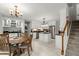 Spacious kitchen and dining area featuring white cabinets, stainless steel appliances, and a staircase nearby at 197 High Grove Rd, Summerville, SC 29485