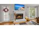 Bright living room with a fireplace, television, white mantle, and access to the outside porch at 197 High Grove Rd, Summerville, SC 29485