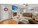 Inviting living room with a cozy fireplace, hardwood floors, and comfortable brown sofas at 197 High Grove Rd, Summerville, SC 29485