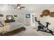 Spacious main bedroom features a ceiling fan, television, and an exercise bike at 197 High Grove Rd, Summerville, SC 29485