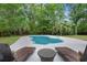 A private pool surrounded by a deck with lounge chairs and a small table, perfect for enjoying the outdoors at 197 High Grove Rd, Summerville, SC 29485