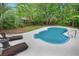Private backyard oasis featuring a uniquely-shaped pool, lounge chairs, and lush landscaping for ultimate relaxation at 197 High Grove Rd, Summerville, SC 29485