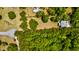 An aerial view showcasing a home on a large lot, surrounded by lush greenery and mature trees for privacy at 1976 Liberia Rd, Wadmalaw Island, SC 29487