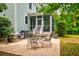 Outdoor patio with dining set, grill, and view of the screened-in porch at 1976 Liberia Rd, Wadmalaw Island, SC 29487